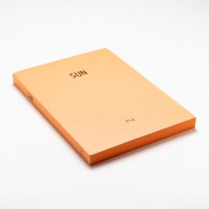 Pages of SUN notebook have bright orange sun colour, design by Noritake