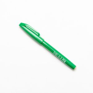 green pen with text "This is a pen", designed by Noritake