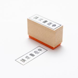 ink stamp with text "INVOICE INCLUDED" in Japanese kanji characters, designed by Noritake